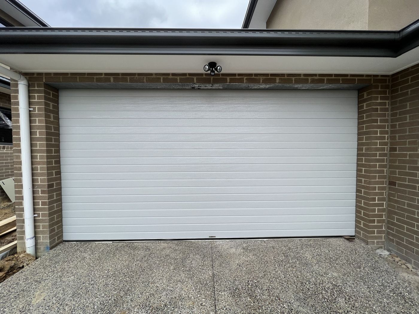 White roller door on a brick home